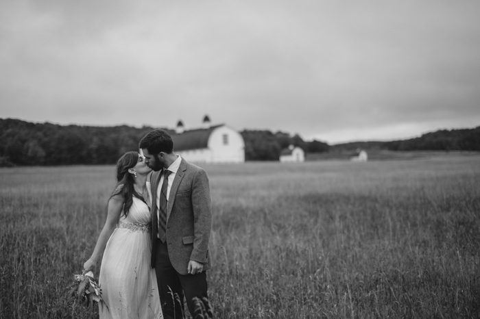black and white wedding portrait in a field