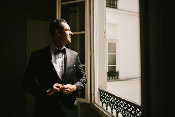 groom looking out Paris window