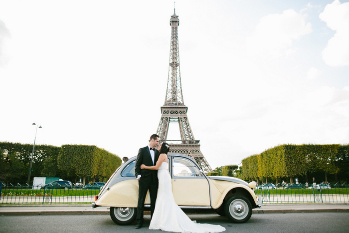 bride and groom in front of eiffel tower