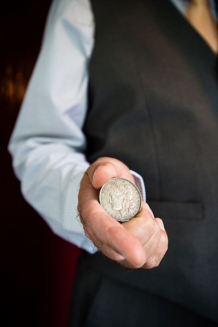 man holding large coin