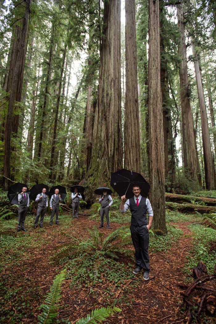 groomsmen portrait with umbrellas in the forest