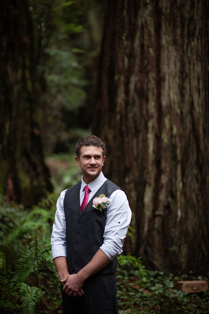 groomwaiting for his bride in the redwoods