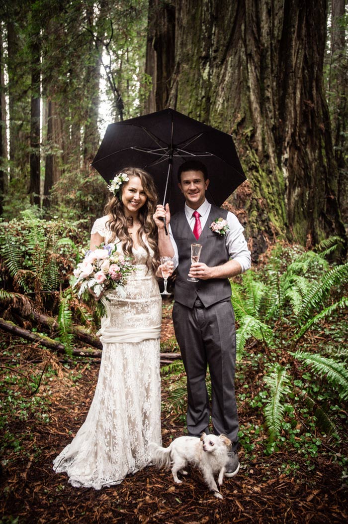 bride and groom portrait under umbrella in the woods