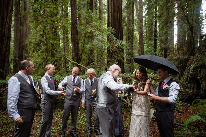 father of the bride pouring champagne in the woods